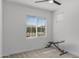 Bedroom featuring neutral carpet, ceiling fan, and large window letting in ample natural light at 16430 W Alameda Rd, Surprise, AZ 85387