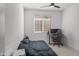 Bedroom featuring neutral carpet, ceiling fan, and large window letting in ample natural light at 16430 W Alameda Rd, Surprise, AZ 85387