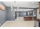 Open dining space with modern light fixture, sleek design, and easy access to kitchen at 16430 W Alameda Rd, Surprise, AZ 85387