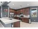 Modern kitchen with stainless steel appliances, white countertops, and rich wooden cabinets at 16430 W Alameda Rd, Surprise, AZ 85387