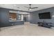 Open-concept living area with gray walls, tile floors, and modern lighting fixtures at 16430 W Alameda Rd, Surprise, AZ 85387