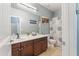 Bathroom boasts double sinks, a large mirror, and a shower with a curtain at 1700 W Paisley Dr, San Tan Valley, AZ 85144