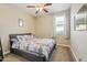 Cozy bedroom features a ceiling fan, window, and colorful comforter set at 1700 W Paisley Dr, San Tan Valley, AZ 85144