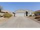 Charming single-Gathering home with a two-car garage, desert landscaping, and a long driveway at 1700 W Paisley Dr, San Tan Valley, AZ 85144