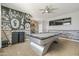 Stylish game room featuring a sleek pool table, custom wall art, and a ceiling fan at 1700 W Paisley Dr, San Tan Valley, AZ 85144