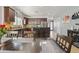 A dining area adjacent to an open kitchen, featuring stainless steel appliances and dark wood cabinets at 1700 W Paisley Dr, San Tan Valley, AZ 85144