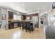 Bright kitchen features a central island with bar seating, stainless steel appliances, and tiled flooring at 1700 W Paisley Dr, San Tan Valley, AZ 85144