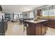 Open-concept kitchen with a granite island, dark cabinetry, and stainless steel appliances at 1700 W Paisley Dr, San Tan Valley, AZ 85144