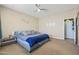 A spacious main bedroom featuring neutral paint colors, soft carpet, and a large bed at 1700 W Paisley Dr, San Tan Valley, AZ 85144