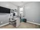 Well-lit office space with a desk, computer, floating shelves, and grey walls at 1700 W Paisley Dr, San Tan Valley, AZ 85144