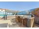 This backyard boasts an outdoor kitchen with a grill, bar seating and hot tub at 1700 W Paisley Dr, San Tan Valley, AZ 85144