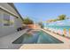 Sparkling pool surrounded by a muraled fence and backyard landscape at 1700 W Paisley Dr, San Tan Valley, AZ 85144