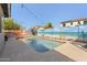 Swimming pool in backyard with mural, houses, and landscaping at 1700 W Paisley Dr, San Tan Valley, AZ 85144
