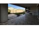 Inviting back patio with built-in outdoor kitchen, tiled flooring, and an artificial lawn at 17168 W Middlebury St, Surprise, AZ 85388