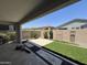 Captivating backyard with artificial turf, desert landscaping, and tiled patio for easy outdoor living at 17168 W Middlebury St, Surprise, AZ 85388