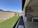 Relaxing backyard featuring artificial turf, gravel landscaping, and a built-in barbecue with a hood at 17168 W Middlebury St, Surprise, AZ 85388