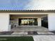 Spacious backyard patio with an outdoor kitchen, tile flooring and artificial lawn at 17168 W Middlebury St, Surprise, AZ 85388