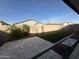 Backyard featuring a tiled patio, privacy wall and strip of artificial turf at 17168 W Middlebury St, Surprise, AZ 85388