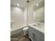 Bright bathroom featuring a shower-tub combo, toilet, and vanity with a white countertop at 17168 W Middlebury St, Surprise, AZ 85388