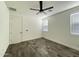 Neutral bedroom with ceiling fan, tile floor, and two windows at 17168 W Middlebury St, Surprise, AZ 85388