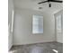 Bedroom with two windows, wood-style tile floor, ceiling fan, and minimal design at 17168 W Middlebury St, Surprise, AZ 85388