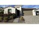 Charming single-Gathering house with a two-car garage, landscaping, and concrete walkway at 17168 W Middlebury St, Surprise, AZ 85388