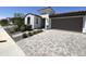 Beautiful home featuring a paver driveway, two-car garage, desert landscaping, and a neutral color scheme at 17168 W Middlebury St, Surprise, AZ 85388