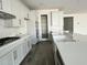 Bright, spacious kitchen featuring white cabinets, a large island, and modern stainless steel appliances, with seamless flow into other rooms at 17168 W Middlebury St, Surprise, AZ 85388