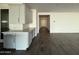 Open-concept kitchen area with white cabinets, quartz countertops, and tile backsplash at 17168 W Middlebury St, Surprise, AZ 85388