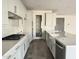 Bright kitchen features white cabinets, stainless steel appliances, and a large center island with a farmhouse sink at 17168 W Middlebury St, Surprise, AZ 85388