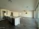 Kitchen island with quartz countertop, stainless steel sink, and open floor plan at 17168 W Middlebury St, Surprise, AZ 85388
