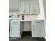 Kitchen features a counter work space with light gray cabinets, stylish hardware, and white subway tile backsplash at 17168 W Middlebury St, Surprise, AZ 85388