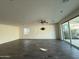 Spacious living room featuring tiled floors, a ceiling fan, recessed lighting, and access to the outdoor space through sliding glass doors at 17168 W Middlebury St, Surprise, AZ 85388