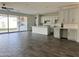 Open floorplan living space with tile floors, backyard access, and kitchen bar at 17168 W Middlebury St, Surprise, AZ 85388