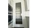 Bright, spacious pantry with shelves, located adjacent to the modern microwave/oven combo in a light and airy kitchen at 17168 W Middlebury St, Surprise, AZ 85388