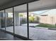 View of the back yard and patio with pavers, rock beds, green space and block wall for privacy at 17168 W Middlebury St, Surprise, AZ 85388