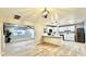 Bright open floor plan featuring a modern kitchen with white cabinets and stainless steel refrigerator at 1803 W 6Th St, Mesa, AZ 85201