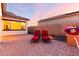 Inviting backyard patio with lounge chairs and desert landscaping; an ideal space to relax outdoors at 18322 W Thistle Landing Dr, Goodyear, AZ 85338