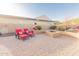 Backyard patio with fire pit and lounge chairs surrounded by desert landscaping at 18322 W Thistle Landing Dr, Goodyear, AZ 85338