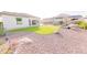 Beautiful backyard features desert landscaping and a manicured lawn, offering a tranquil outdoor space at 18322 W Thistle Landing Dr, Goodyear, AZ 85338