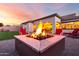 Backyard area featuring a central fire pit with seating, perfect for enjoying evenings outdoors at 18322 W Thistle Landing Dr, Goodyear, AZ 85338