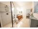 Bright bathroom featuring a glass enclosed shower, tile floors, and a double sink vanity at 18322 W Thistle Landing Dr, Goodyear, AZ 85338