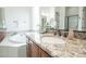 Bright bathroom showcases granite countertop, oval sink, and a luxurious soaking tub at 18322 W Thistle Landing Dr, Goodyear, AZ 85338