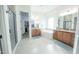 Spacious bathroom featuring dual sinks, a soaking tub, a walk-in shower, and a walk-in closet at 18322 W Thistle Landing Dr, Goodyear, AZ 85338