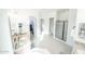 Bathroom featuring granite counters, dual sinks, a walk in shower and a large soaking tub at 18322 W Thistle Landing Dr, Goodyear, AZ 85338