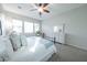 Bright bedroom featuring a white dresser, carpet flooring and an iron bed frame at 18322 W Thistle Landing Dr, Goodyear, AZ 85338