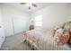 Light-filled bedroom with a ceiling fan, closet, and earth-toned bedding at 18322 W Thistle Landing Dr, Goodyear, AZ 85338