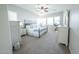 Bright bedroom featuring an iron bed frame, two white dressers, carpet and lots of natural light at 18322 W Thistle Landing Dr, Goodyear, AZ 85338