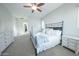 Spacious bedroom featuring a white dresser, carpet flooring and an iron bed frame at 18322 W Thistle Landing Dr, Goodyear, AZ 85338