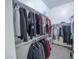 Organized walk-in closet featuring ample hanging space and shelving for storage at 18322 W Thistle Landing Dr, Goodyear, AZ 85338